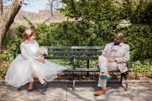 bride and groom sitting on a bench photo idea